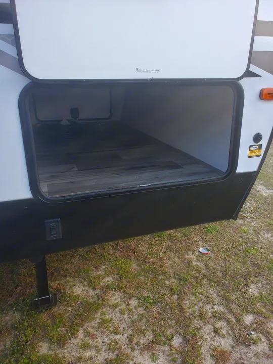Check out this RV rental's spacious open front storage, featuring a solar charging port and leveling jack controls.. Coleman 2455bh 2022