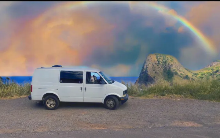 White camper van (RV rental) with a dog overlooking a scenic ocean & mountain vista under a vibrant rainbow.. Chevrolet Other 2005
