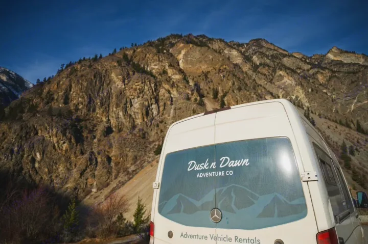 This Dusk n Dawn RV rental van awaits your mountain adventure in a stunning natural landscape.. Mercedes Sprinter 2024