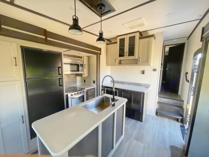 Modern RV rental kitchen with island, full amenities & bright living space. Perfect for your next travel adventure.. Crossroads RV Cruiser Aire 2021