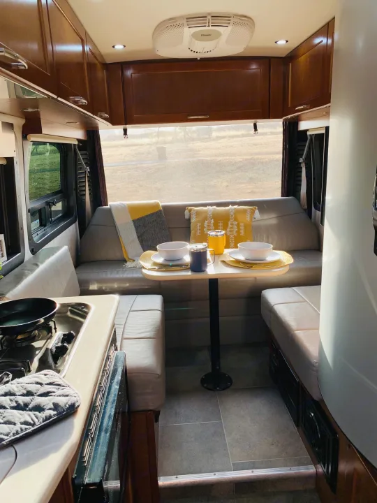 Cozy RV rental interior with dining area, kitchen, and comfy seating, ready for adventure.. Pleasure Way Lexor 2017