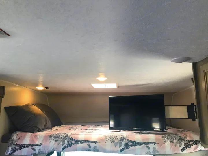 Sleep soundly in this RV rental's over-cab bed with a TV, perfect for a relaxing getaway.. Forest River Coachmen Freelander 2019