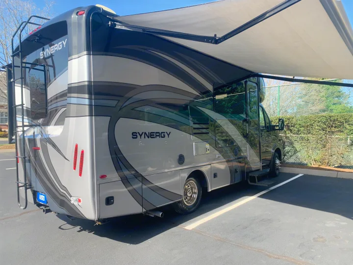 Modern grey Synergy RV rental parked with awning extended, ready for adventure.. Thor Synergy 2018