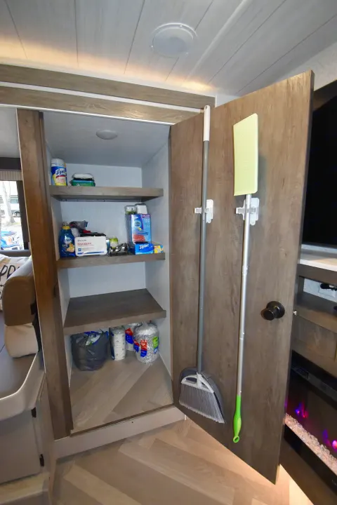This RV rental features a practical utility closet with shelves for cleaning supplies, a First Aid Kit, plus a broom and mop stored on the door.. Forest River Other 2022