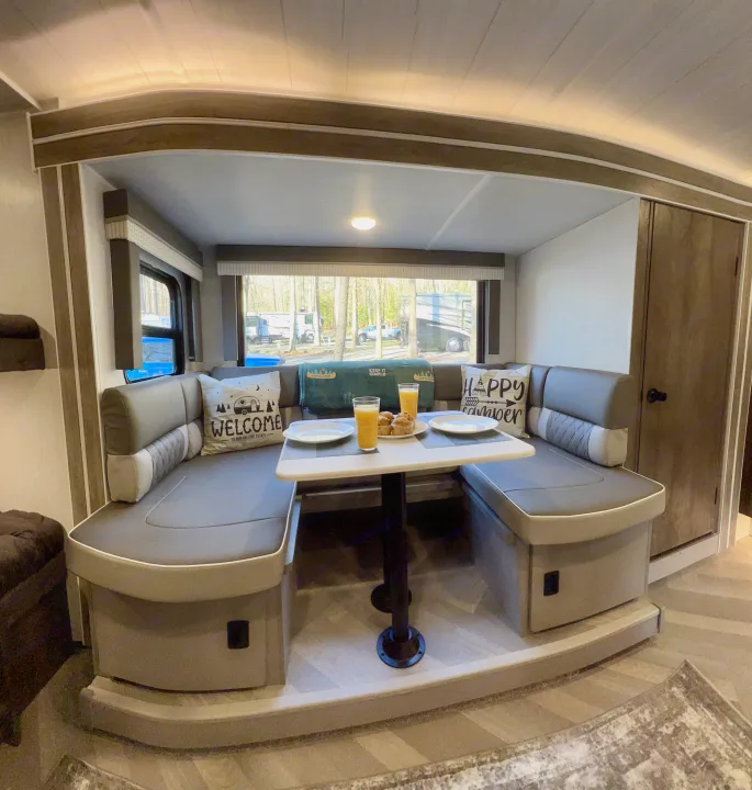 U-shaped RV dinette interior with a table set for breakfast, showcasing comfortable seating. Ideal for an RV rental.. Forest River Other 2022