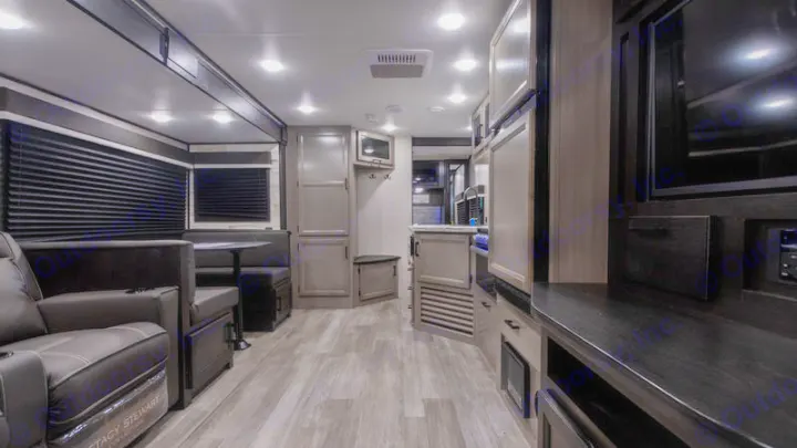 Inside a stylish RV rental: spacious living area, dining booth, and kitchen. Ready for comfortable adventures on the road.. Jayco Jay Feather 2022