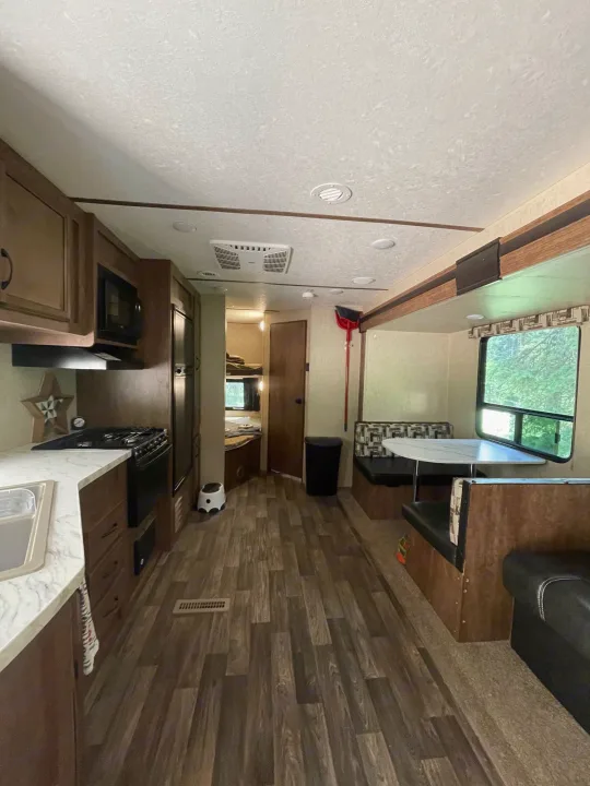 Spacious RV rental interior with a fully equipped kitchen, dinette, and cozy bunk beds.. Starcraft Autumn Ridge 2018
