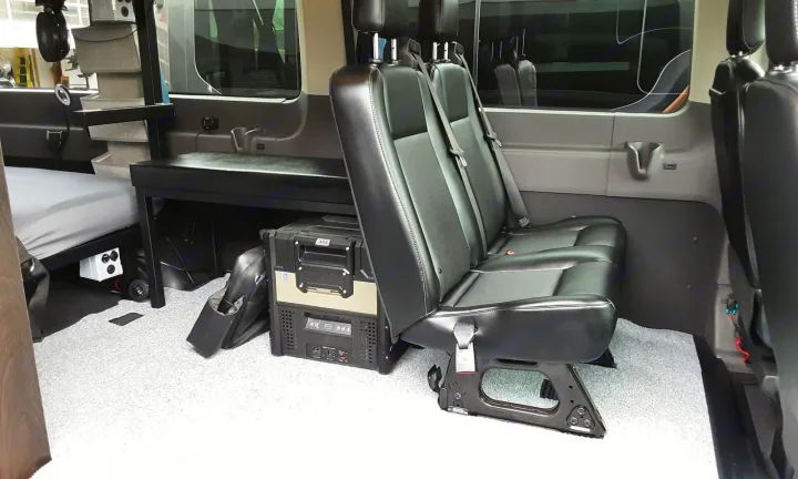 RV rental: Campervan interior with bed, 2nd-row seats, portable fridge, and convenient power outlets.. Ford transit 2017