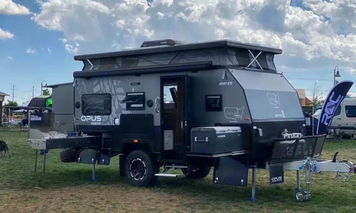 This is a stock photo from Opus of the Caravan set up in camp mode.  This is a "hybrid" trailer where the top and back pop up for more space inside.. Other Other 2022