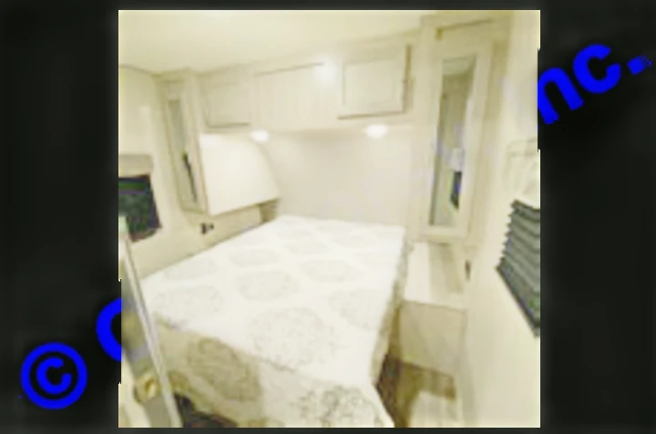 This RV rental bedroom features a queen bed, overhead cabinets, and side wardrobes, offering comfortable travel accommodation.. Coachmen Catalina 2022