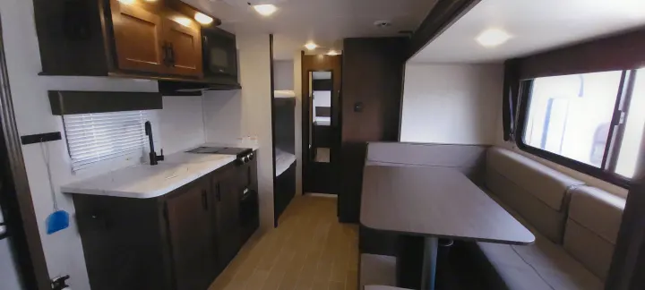Inside this rv rental, a modern kitchen, dinette, and bunk beds offer a complete, compact living space for travelers.. Forest River Wolf Pup 2020