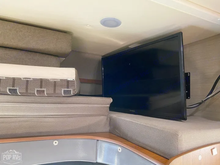 RV rental interior: Stacked bed cushions next to a wall-mounted TV, perfect for a cozy sleeping/living area.. Jayco Melbourne 2016