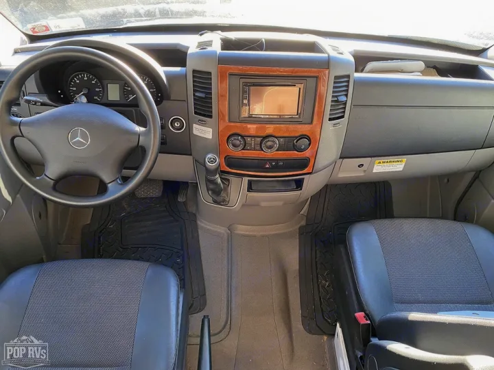 Step inside this RV rental's Mercedes Sprinter cabin, showcasing the clean dashboard, steering wheel, and front seats.. Jayco Melbourne 2016