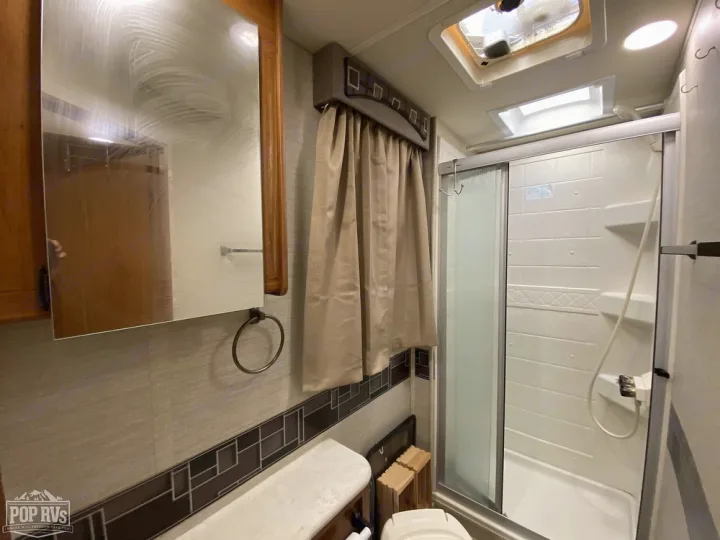 Explore this RV rental's full bathroom. It features a compact shower, vanity with a mirror, and toilet, offering home-like comfort.. Jayco Melbourne 2016