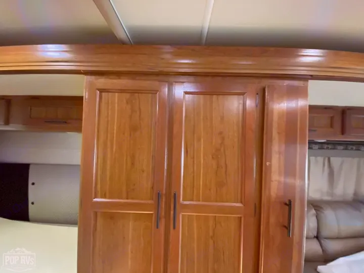 RV rental interior: Warm wooden cabinetry and storage solutions define this cozy camper living space.. Jayco Melbourne 2016
