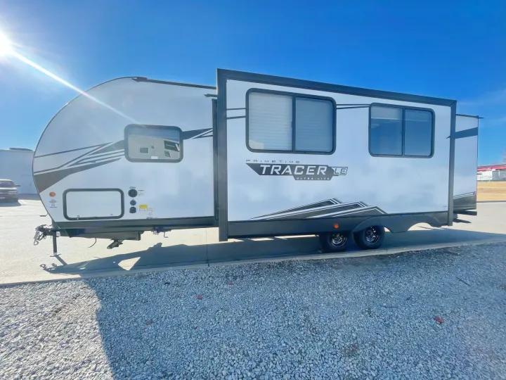 Sunny day highlights a white Tracer LE Ultra-Lite travel trailer, a great option for your RV rental needs.. Forest River PRIME TIME 2022