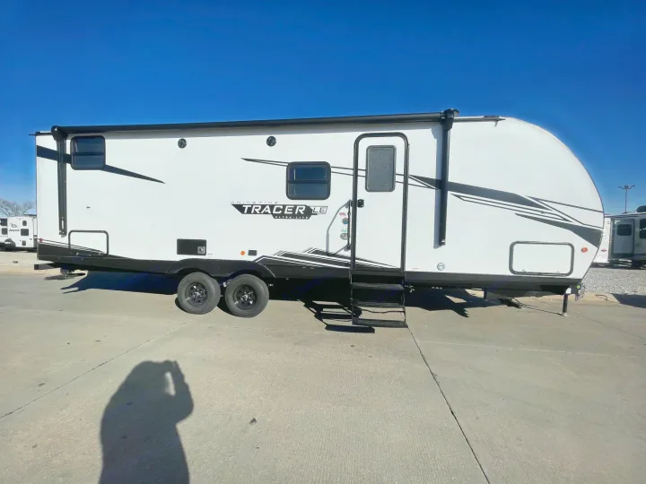Get ready to explore! This modern white Prime Time Tracer LE Ultra-Lite travel trailer is ideal for your next RV rental adventure.. Forest River PRIME TIME 2022