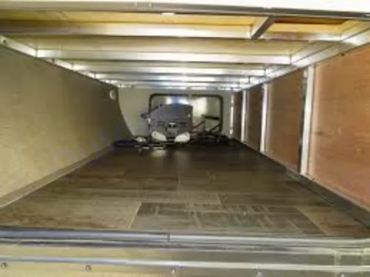 Explore a roomy pass-through storage bay in an RV rental, featuring a wood-look floor, ideal for gear & luggage.. Keystone RV Bullet Ultra Lite 2017