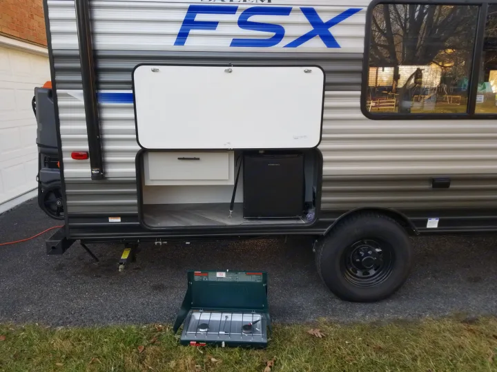 Coleman camping stove, exterior mini fridge, and additional storage for your outdoor cooking experience.. Forest River Salem FSX 2021