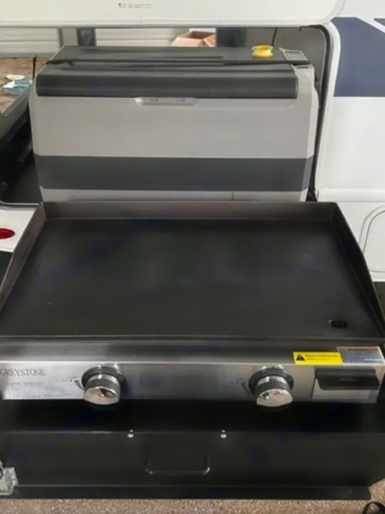 RV rental: Portable refrigerator and Greystone flat-top griddle for easy outdoor cooking, ideal for camping.. Thor Quantum 2022