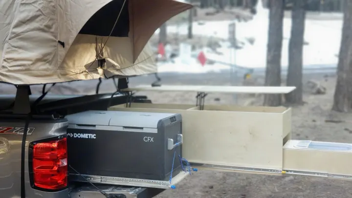 RV rental-ready truck setup: rooftop tent, Dometic cooler, and a pull-out outdoor kitchen with sink.. Chevrolet Silverado 2021