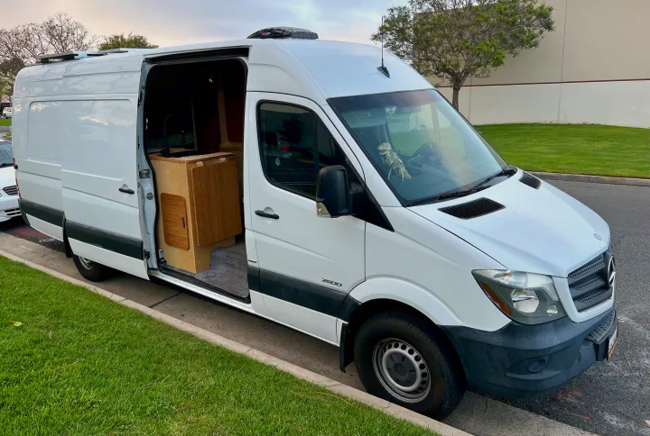 White Mercedes Sprinter camper van for rv rental, showing interior kitchen and roof solar panels.. Mercedes-benz Sprinter 2016
