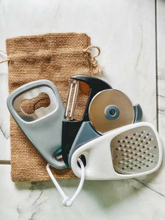 Portable kitchen tools: bottle opener, peeler, pizza cutter, mini grater, and burlap bag. Great for your RV rental trips!. Forest River Other 2022