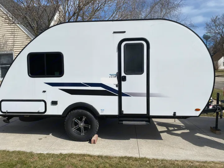 White, compact travel trailer with black trim & graphics. Perfect for your next RV rental adventure.. Braxton Creek Bushwhacker Plus 2022