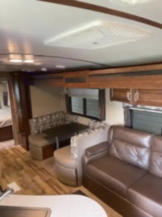 RV rental: Bright, spacious living area with a U-shaped dinette, sofa, and kitchen access. Your travel comfort awaits!. Keystone Outback 2018