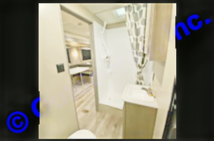 Inside an RV rental: a compact bathroom with shower, sink, and toilet, opening to the modern dinette area. Perfect for travel.. Coachmen Catalina 2022
