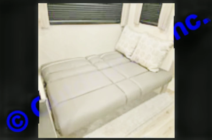 Unfold comfort! This gray sofa bed in an RV rental provides extra sleeping space, ideal for your RV adventure.. Coachmen Catalina 2022