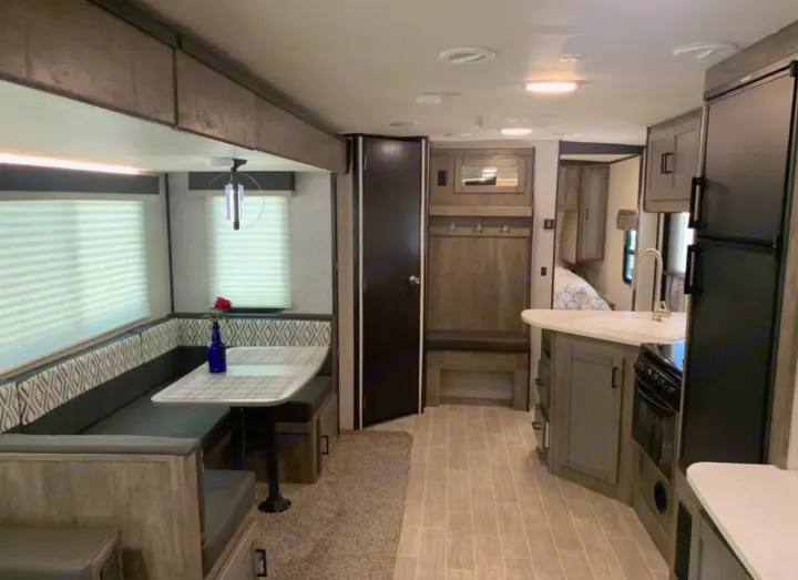 Modern RV rental interior showcasing a full kitchen, comfortable dinette, and ample living space for your road trips.. Heartland Wilderness 2020