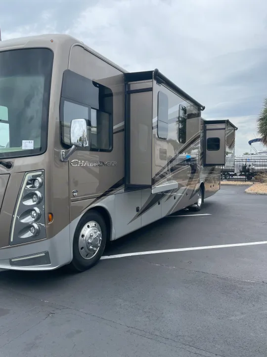 Large, modern Thor Challenger motorhome, parked with slide-outs extended, perfect for your next RV rental adventure.. Thor Challenger 2021