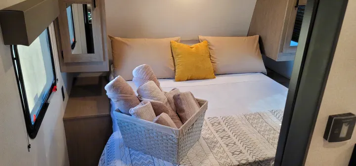 Step inside this cozy RV rental! Enjoy a comfortable bed with soft linens, pillows, and fresh towels.. Keystone RV Hideout Luxury Edition 2021