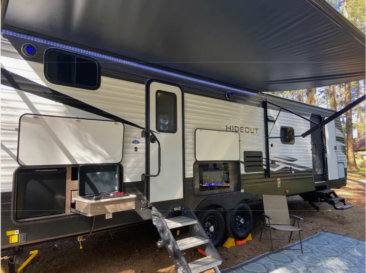 This RV rental offers a great outdoor setup with a kitchen, electric fireplace, and lighted awning for your next camping trip.. Keystone RV Hideout Luxury Edition 2021