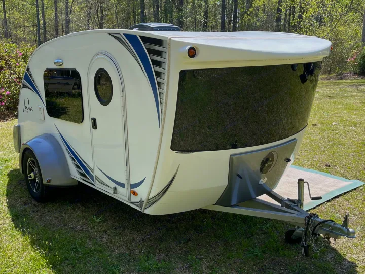 White & blue teardrop travel trailer for rv rental. Luna camper parked on grass, ready for adventure.. InTech RV InTech RV Trailer 2018