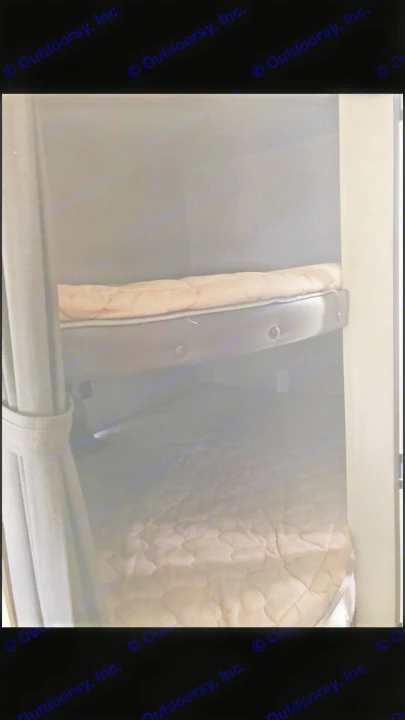 View of two comfortable bunk beds inside an RV rental. Each bunk features a quilted mattress, ideal for travelers.. Jayco Coyote 2014