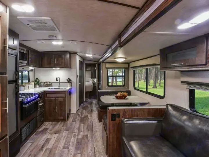 Spacious RV rental interior with a modern kitchen, cozy dinette, and comfortable sofa, perfect for your next adventure.. Radiance Big Bear 2020
