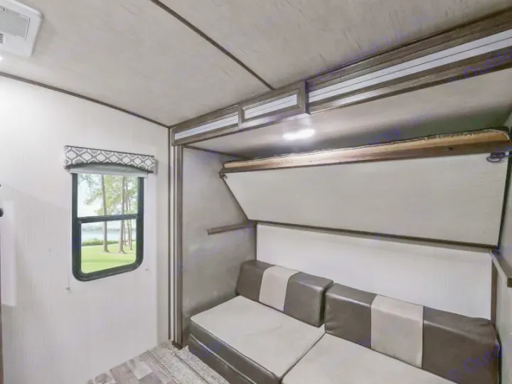 RV rental interior: sofa, fold-down bunk bed, and window with a serene lake view. Great for camper adventures!. Radiance Big Bear 2020