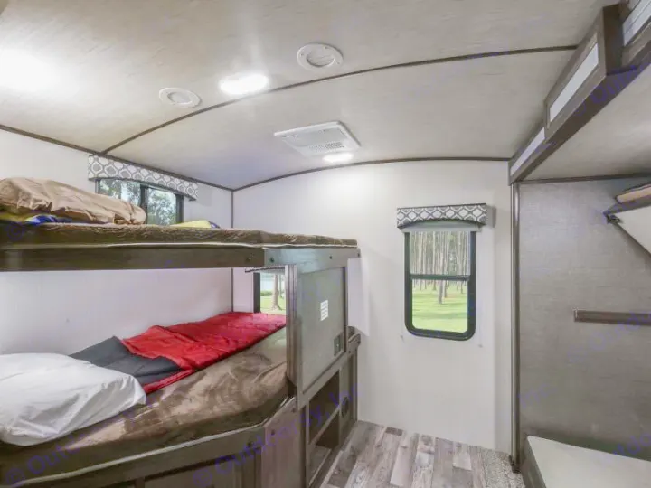 Cozy RV rental bunk beds, fully made with bedding, offer comfortable sleeping & a view of nature.. Radiance Big Bear 2020
