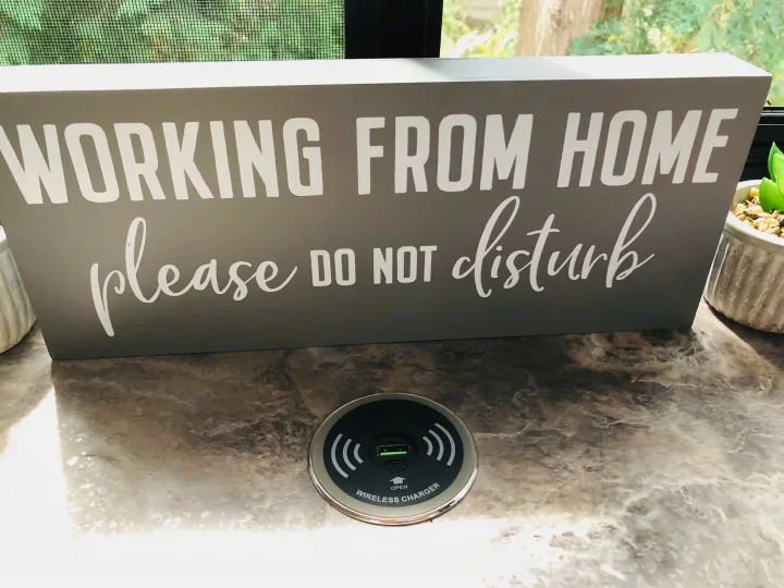 RV rental comfort: Dedicated "Working From Home" sign with built-in wireless charger for productivity on the go.. Thor Chateau 2022