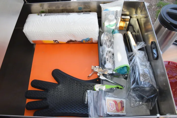 Stocked kitchen drawer for your RV rental adventure, featuring paper towels, Campsuds, Cuisinart mitt, & camp essentials.. Toyota 4Runner 2021