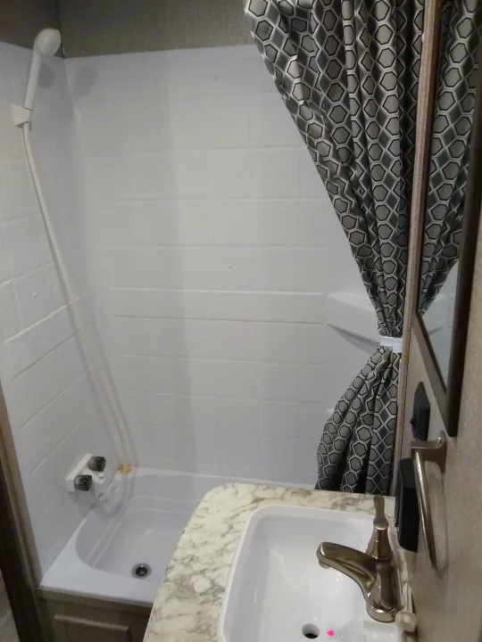 RV rental: Compact bathroom with a shower/tub combo and sink, equipped for travel accommodation.. Jayco Jay Flight SLX 2021