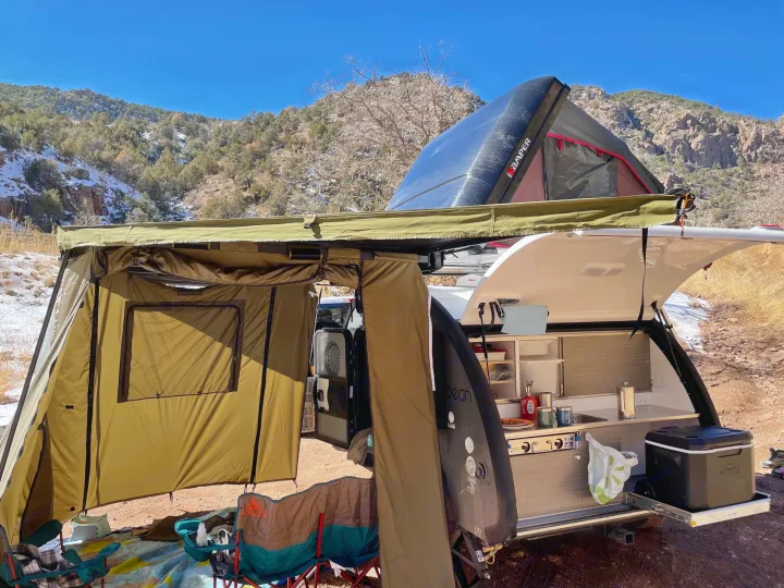 RV rental adventure: Teardrop trailer with tent extension, rooftop tent, & outdoor kitchen set up for camping in snowy mountains.. Bean Mean Bean 2022