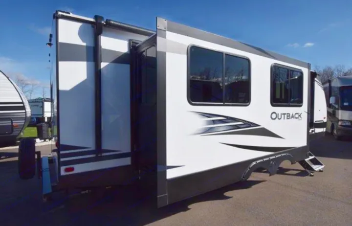 Modern white and black recreational vehicle (RV) rental, an Outback model with extended slide-out, ready for adventure.. Keystone RV Outback Ultra-Lite 2020