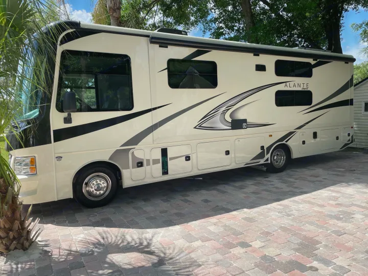 Cream Jayco Alante RV rental motorhome with black graphics, parked on a brick driveway. Ready for your travel adventures.. Other Other 2022
