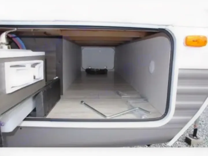RV rental: Clean, empty pass-through storage compartment. Utility access seen on left, ready for use.. Other Other 2021
