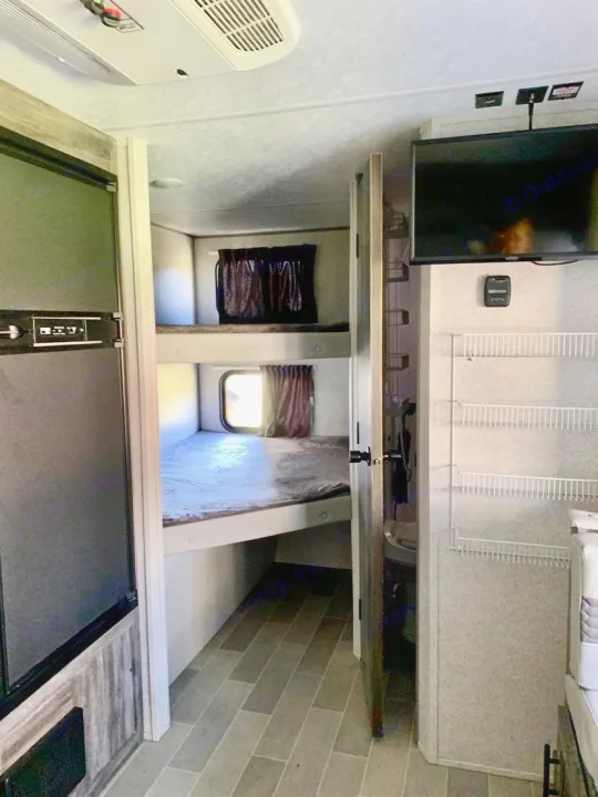 RV rental interior features bunk beds, refrigerator, TV, and pantry storage. Cozy, functional living for your adventures.. Forest River Salem FSX PLATINUM 2020
