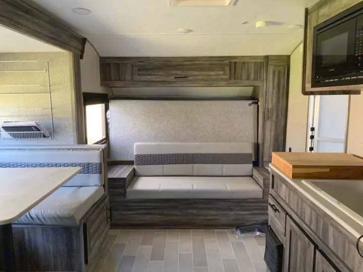 RV rental: Modern interior with dinette booth, sofa, wall bed, and compact kitchen area.. Forest River Salem FSX PLATINUM 2020