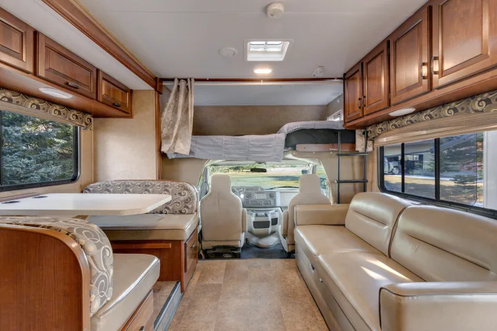 Spacious rv rental interior featuring a living area, dinette, kitchen, and overhead bunk. Ideal for comfortable travel.. Forest River Sunseeker 2014